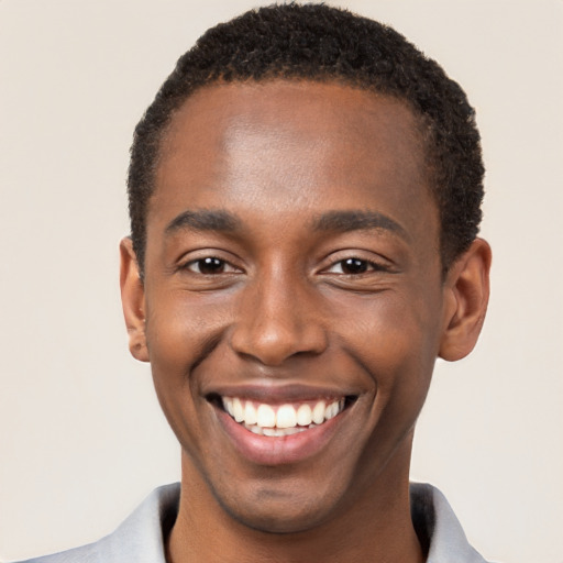 Joyful black young-adult male with short  brown hair and brown eyes