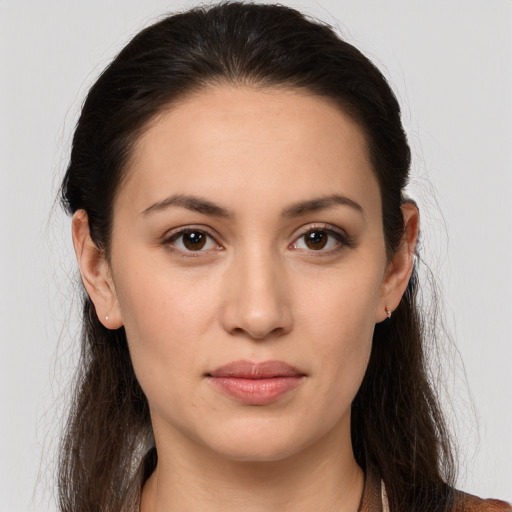 Joyful white young-adult female with long  brown hair and brown eyes