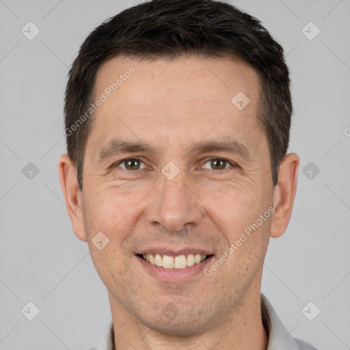 Joyful white adult male with short  brown hair and brown eyes