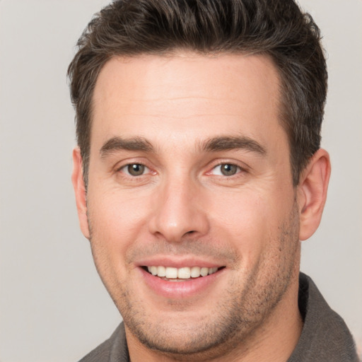 Joyful white young-adult male with short  brown hair and brown eyes