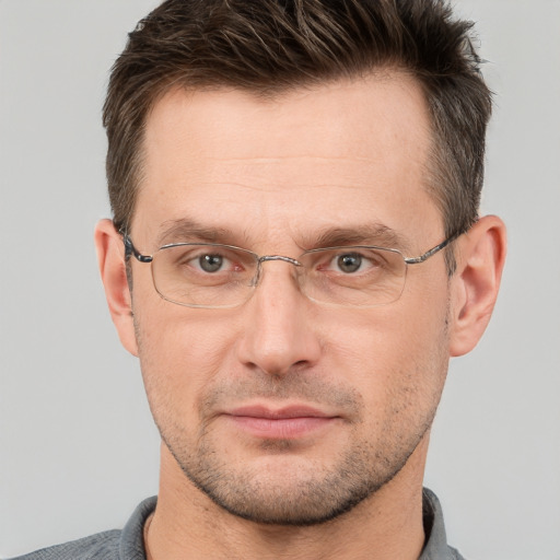 Joyful white adult male with short  brown hair and brown eyes