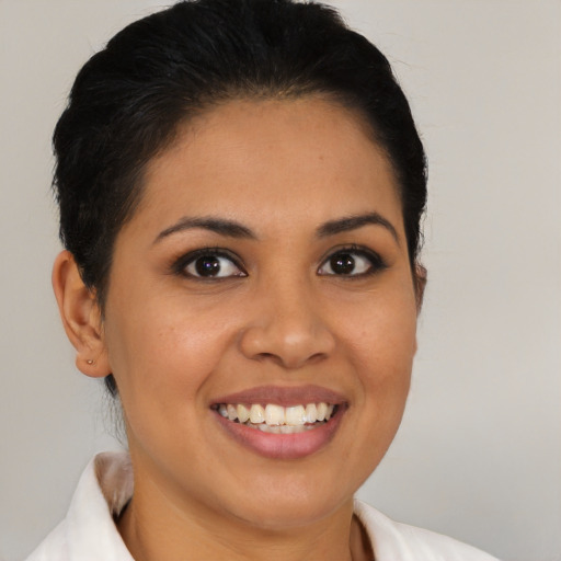 Joyful latino young-adult female with medium  brown hair and brown eyes