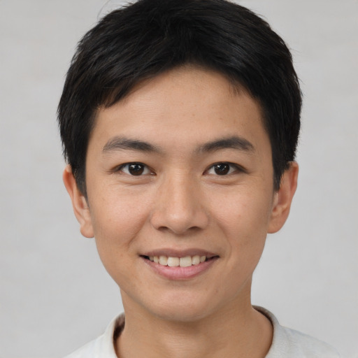 Joyful asian young-adult male with short  brown hair and brown eyes