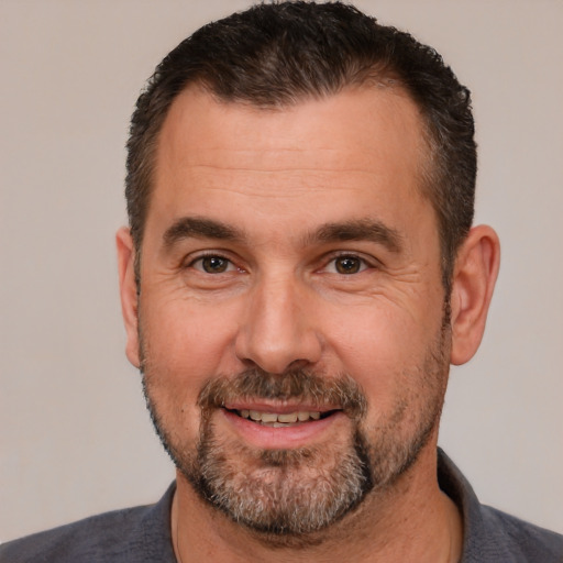 Joyful white adult male with short  brown hair and brown eyes