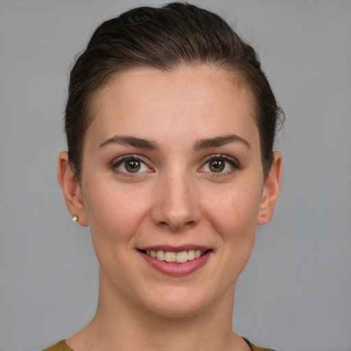 Joyful white young-adult female with short  brown hair and grey eyes