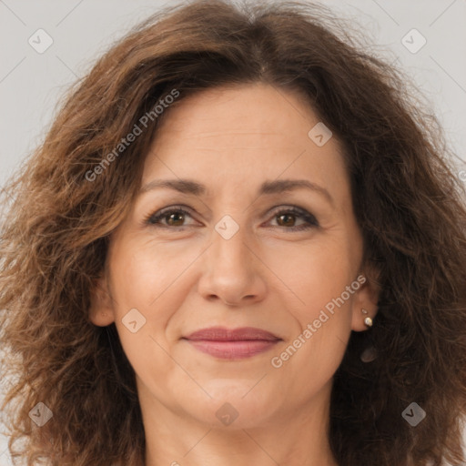 Joyful white adult female with long  brown hair and brown eyes