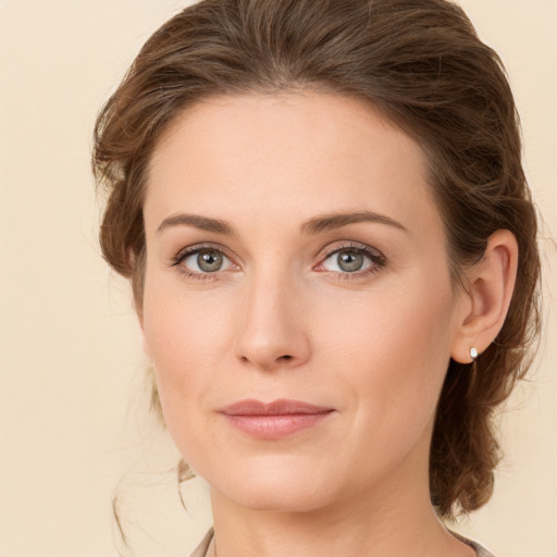 Joyful white young-adult female with medium  brown hair and green eyes