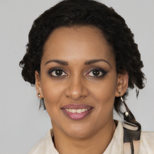 Joyful black young-adult female with medium  brown hair and brown eyes