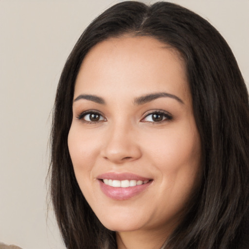 Joyful white young-adult female with long  black hair and brown eyes