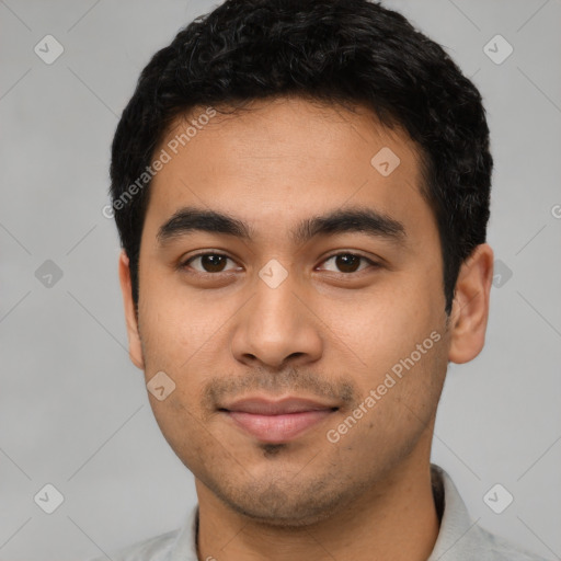 Joyful latino young-adult male with short  black hair and brown eyes