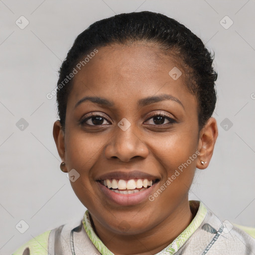 Joyful black young-adult female with short  black hair and brown eyes