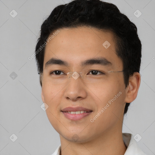 Joyful asian young-adult male with short  black hair and brown eyes