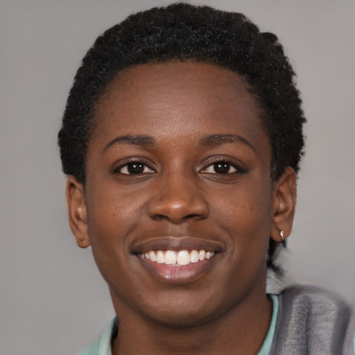 Joyful black young-adult female with short  brown hair and brown eyes
