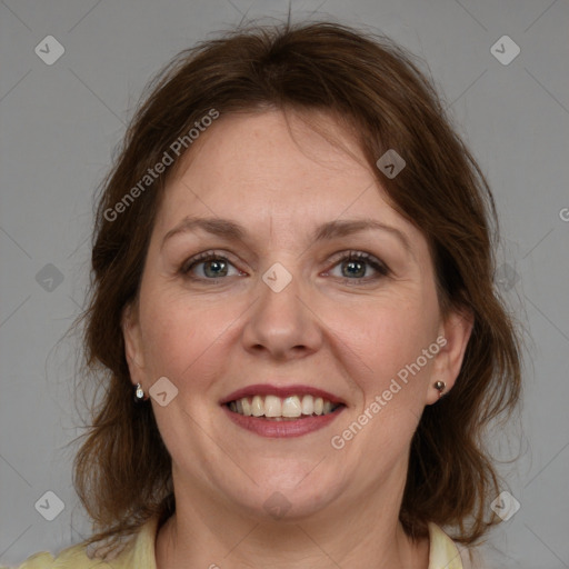 Joyful white adult female with medium  brown hair and grey eyes