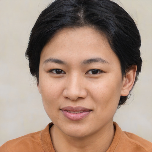 Joyful asian young-adult female with medium  brown hair and brown eyes