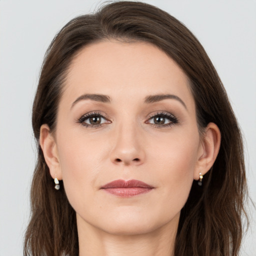 Joyful white young-adult female with long  brown hair and grey eyes