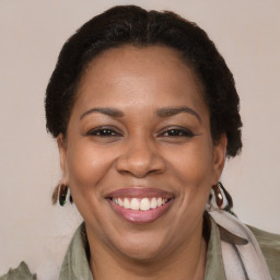 Joyful black adult female with medium  brown hair and brown eyes