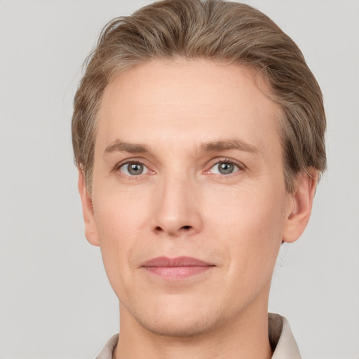 Joyful white adult male with short  brown hair and grey eyes