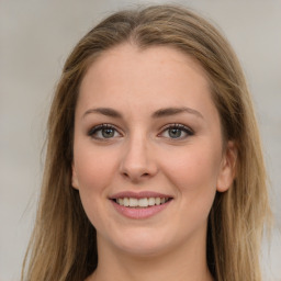 Joyful white young-adult female with long  brown hair and green eyes