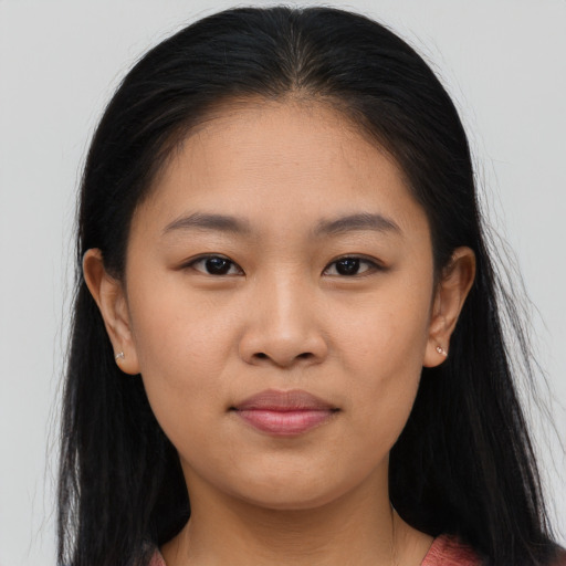 Joyful asian young-adult female with long  brown hair and brown eyes