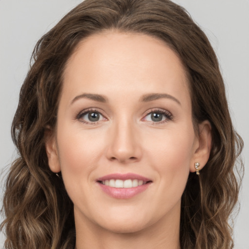 Joyful white young-adult female with long  brown hair and green eyes