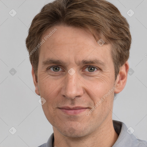 Joyful white adult male with short  brown hair and grey eyes