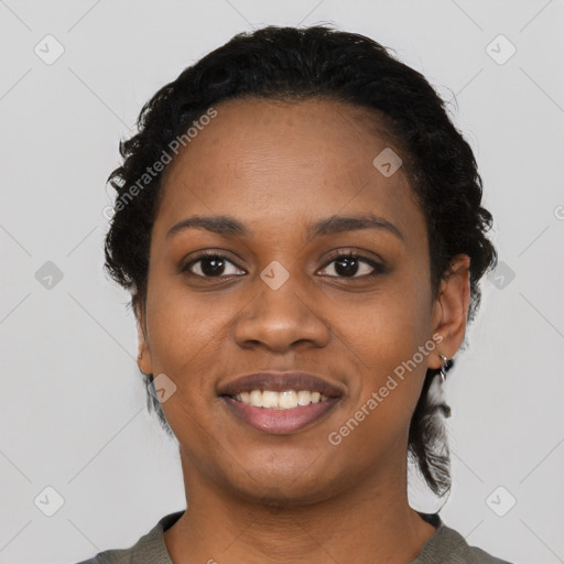 Joyful black young-adult female with short  black hair and brown eyes