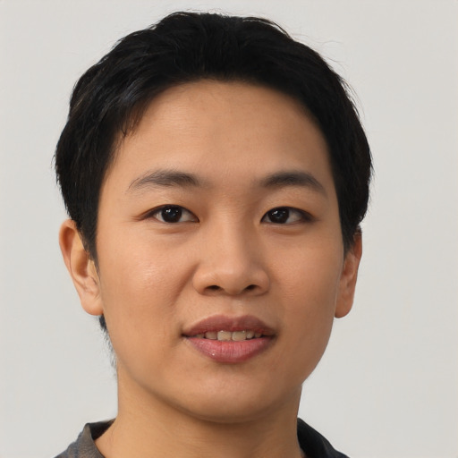 Joyful asian young-adult male with short  black hair and brown eyes