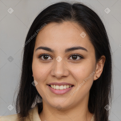 Joyful latino young-adult female with long  brown hair and brown eyes