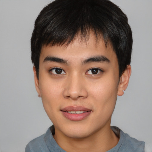 Joyful asian young-adult male with short  brown hair and brown eyes