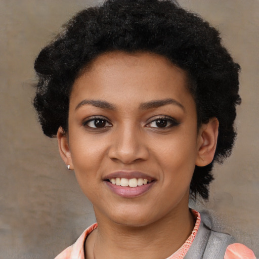 Joyful black young-adult female with short  black hair and brown eyes