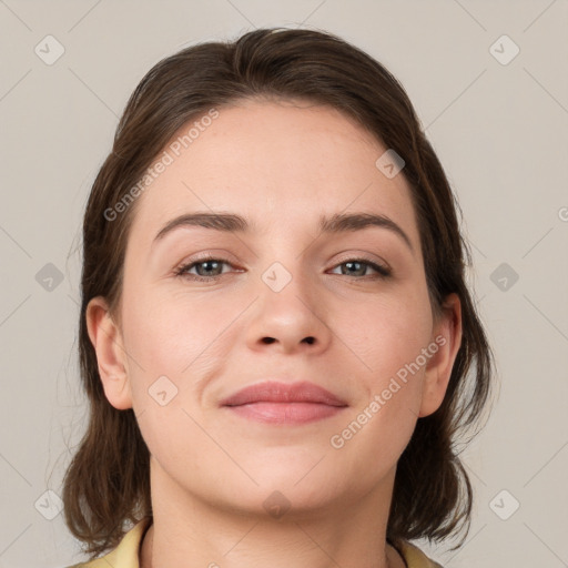 Joyful white young-adult female with medium  brown hair and brown eyes