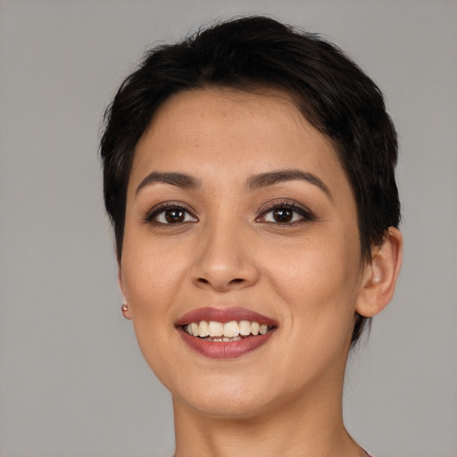 Joyful latino young-adult female with short  brown hair and brown eyes
