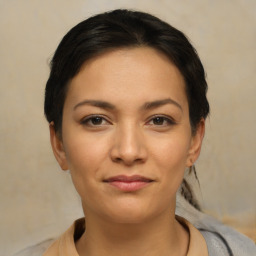 Joyful latino young-adult female with medium  brown hair and brown eyes