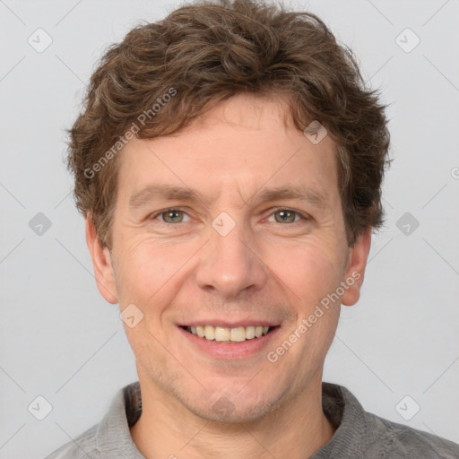 Joyful white adult male with short  brown hair and grey eyes