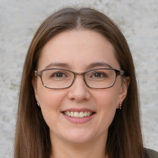 Joyful white young-adult female with long  brown hair and grey eyes