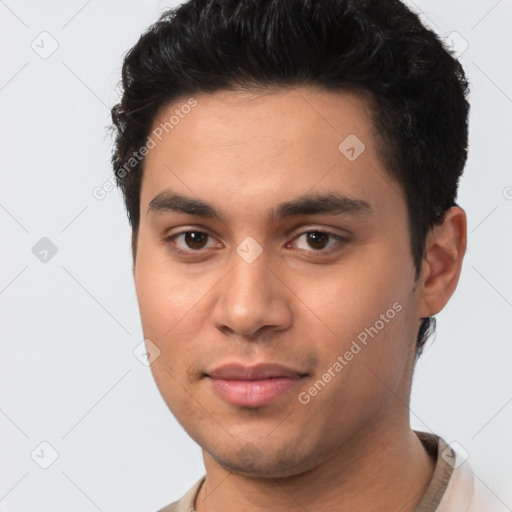 Joyful latino young-adult male with short  brown hair and brown eyes