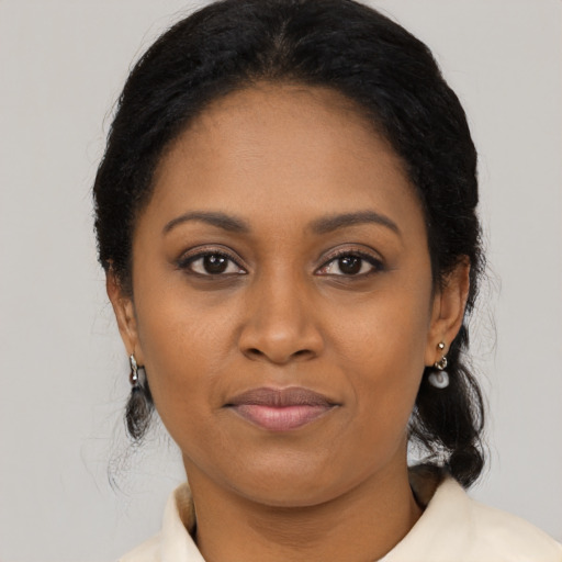 Joyful black young-adult female with medium  black hair and brown eyes