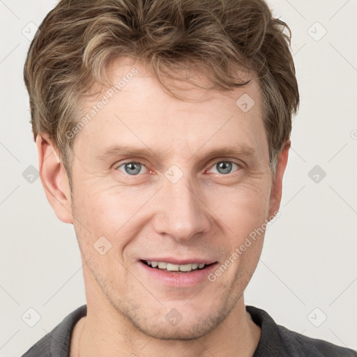 Joyful white adult male with short  brown hair and grey eyes