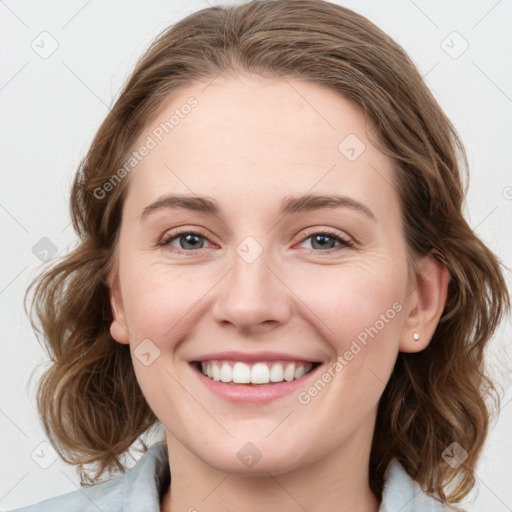 Joyful white young-adult female with medium  brown hair and blue eyes