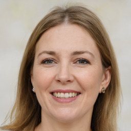 Joyful white adult female with medium  brown hair and brown eyes