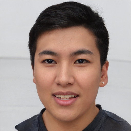 Joyful asian young-adult male with short  black hair and brown eyes