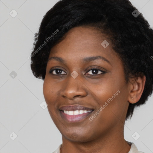 Joyful black young-adult female with short  black hair and brown eyes