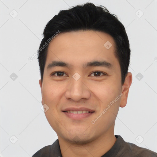 Joyful asian young-adult male with short  black hair and brown eyes