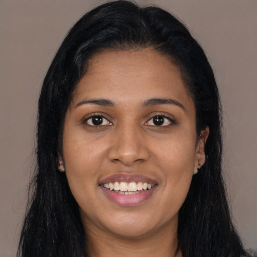 Joyful latino young-adult female with long  black hair and brown eyes