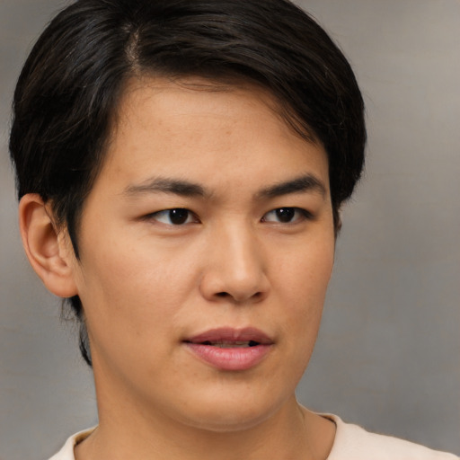 Joyful asian young-adult female with short  brown hair and brown eyes