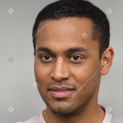 Joyful black young-adult male with short  black hair and brown eyes