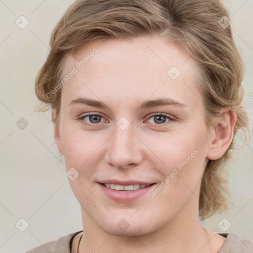 Joyful white young-adult female with medium  brown hair and blue eyes