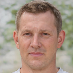 Joyful white adult male with short  brown hair and brown eyes