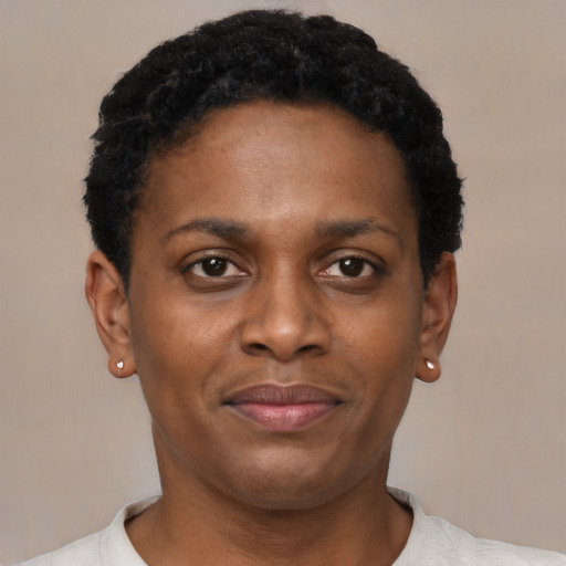 Joyful black young-adult female with short  black hair and brown eyes